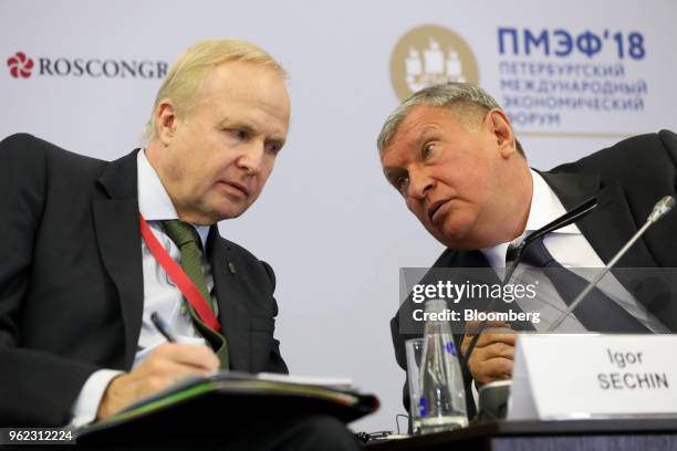 Bob Dudley, chief executive officer of BP Plc, left, listens to Igor Sechin, chief executive officer of Rosneft PJSC, during a panel debate at the...