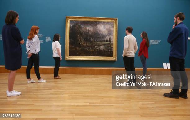 Gallery staff looking at John Constable's Salisbury Cathedral from the Meadows during a photo call for Tate Britain's new exhibition, Fire and Water,...