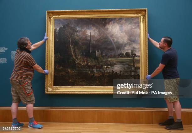 Gallery staff hold John Constable's Salisbury Cathedral from the Meadows during a photo call for Tate Britain's new exhibition, Fire and Water, a...