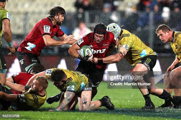 Matt Todd of the Crusaders is held in a tackle during the round 15 Super Rugby match between the Crusaders and the Hurricanes at AMI Stadium on May...