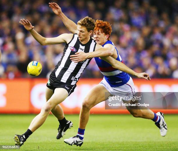 Will Hoskin-Elliott is tackled by Ed Richards of the Bulldogs during the round 10 AFL match between the Collingwood Magpies and the Western Bulldogs...