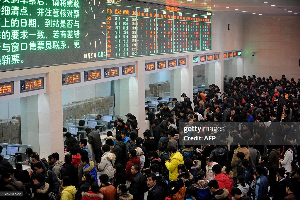 Queue Inchina Chinese passengers queue up to buy train tickets at the new railway ...