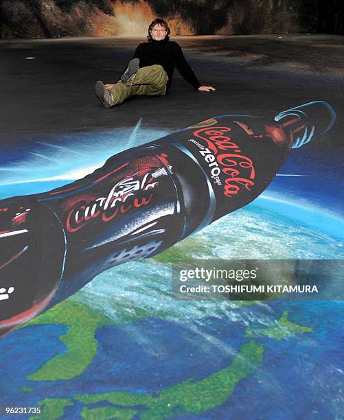 German street artist Edgar Muller poses on 3D art, "Space of zero Gravity" during a press preview in Tokyo on January 28, 2010. AFP PHOTO / TOSHIFUMI...