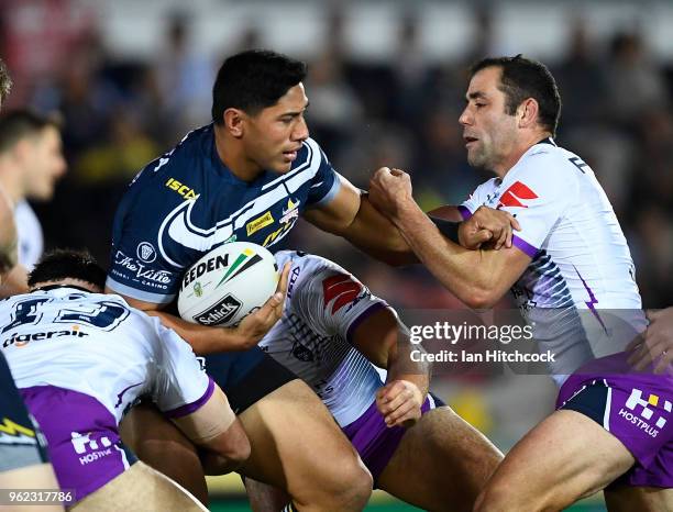 Jason Taumalolo of the Cowboys is tackled by Cameron Smith of the Storm during the round 12 NRL match between the North Queensland Cowboys and the...