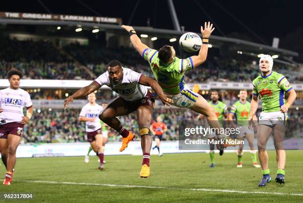 Akuila Uate of the Eagles and Nikola Cotric of the Raiders contest a high ball during the round 12 NRL match between the Canberra Raiders and the...