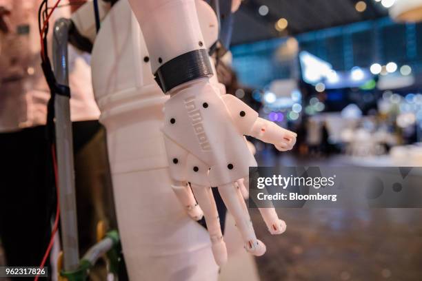 An InMoov robotic hand, assembled from 3-D printed parts, hangs from a humanoid robot on the company's stand during the Viva Technology conference in...