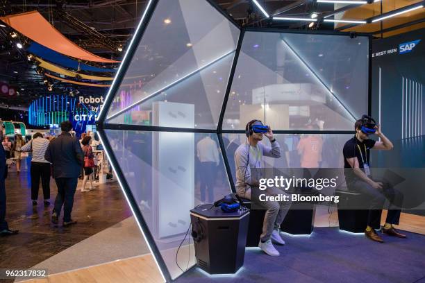 Visitors wear augmented reality headsets on the SAP SE booth during the Viva Technology conference in Paris, France, on Thursday, May 24, 2018. Viva...