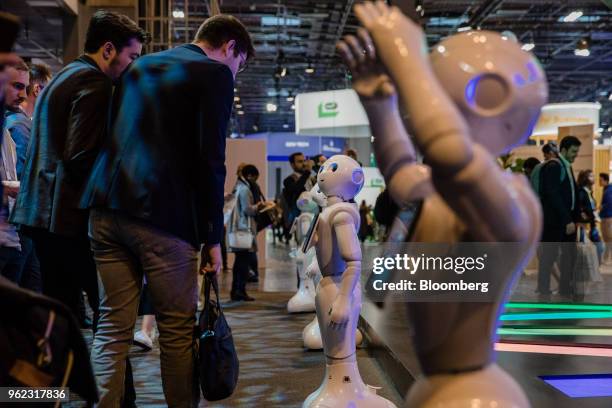 Attendees are greeted by SoftBank Group Corp. Pepper humanoid robots during the Viva Technology conference in Paris, France, on Thursday, May 24,...