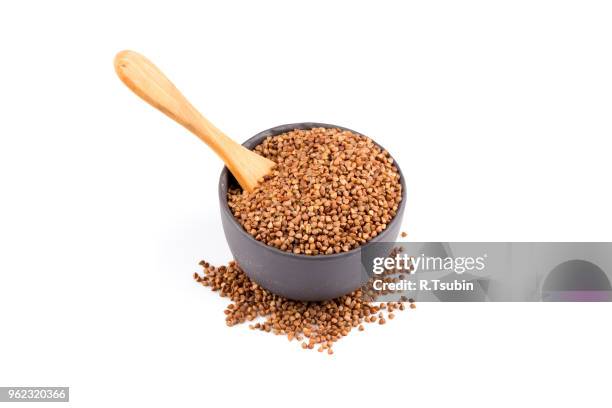 buckwheat groats in a bowl, close up photo - buckwheat isolated stock pictures, royalty-free photos & images