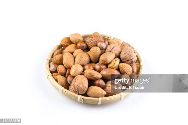 mix nuts in wicker basket on white background - macro shell stock pictures, royalty-free photos & images