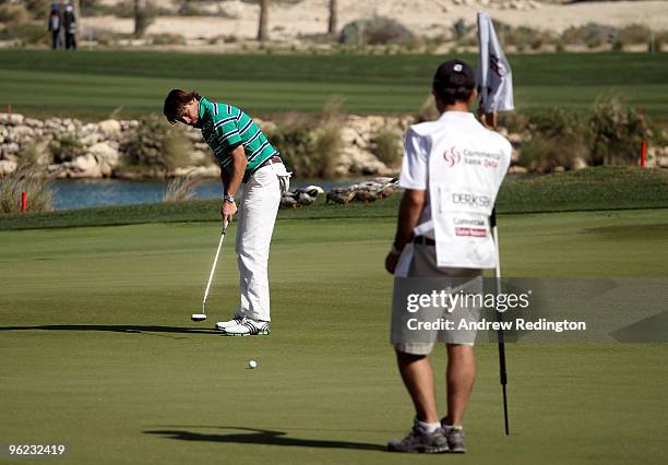 Robert Jan Derksen of The Netherlands watches his putt on the 18th hole during the first round of the Commercialbank Qatar Masters at Doha Golf Club...