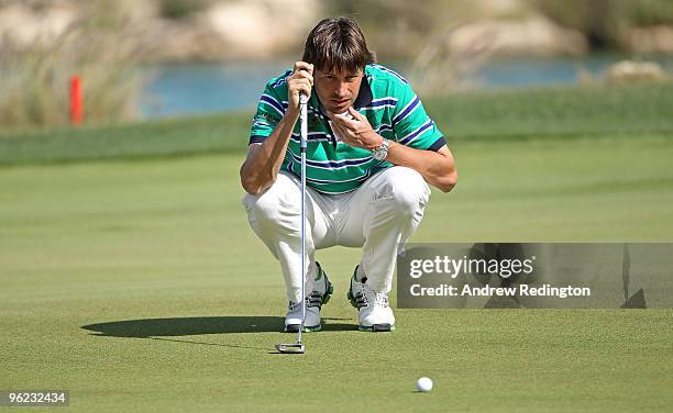 Robert Jan Derksen of The Netherlands lines up a putt on the 18th hole during the first round of the Commercialbank Qatar Masters at Doha Golf Club...