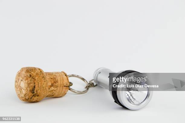 cava cork keyring holding flashlight - cork stopper bildbanksfoton och bilder