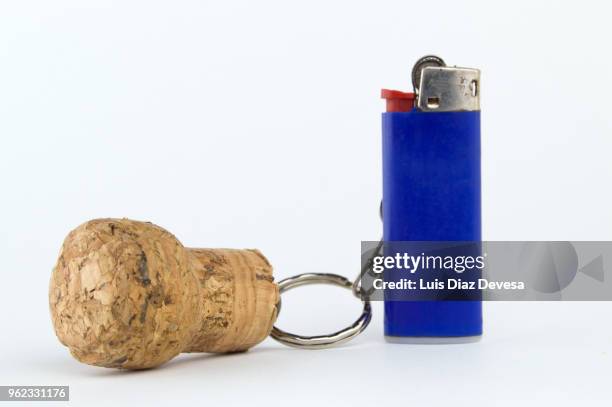 cava cork keyring holding blue cigarette lighter - cork stopper bildbanksfoton och bilder