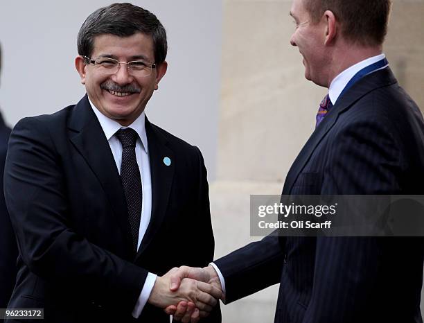 The Turkish Minister of Foreign Affairs Ahmet Davutoglu is greeted by Deputy Leader of the House of Commons Chris Bryant MP as he arrives to attend...