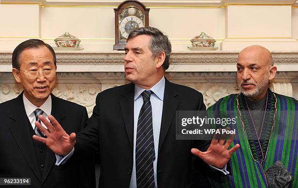 Britain's Prime Minister Gordon Brown poses with Ban Ki Moon and Afghan President Hamid Karzai inside 10 Downing Street ahead of the Afghanistan...