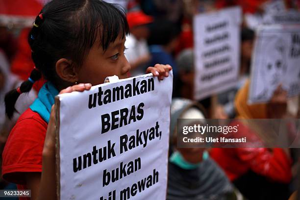 Child holds a poster as indonesians stage a mass anti-government protest, as President Susilo Bambang Yudhoyono marks his 100th day in office, at...