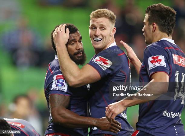 Marika Koroibete of the Rebels is congratulated by his teammates after scoring his third try during the round 15 Super Rugby match between the Rebels...