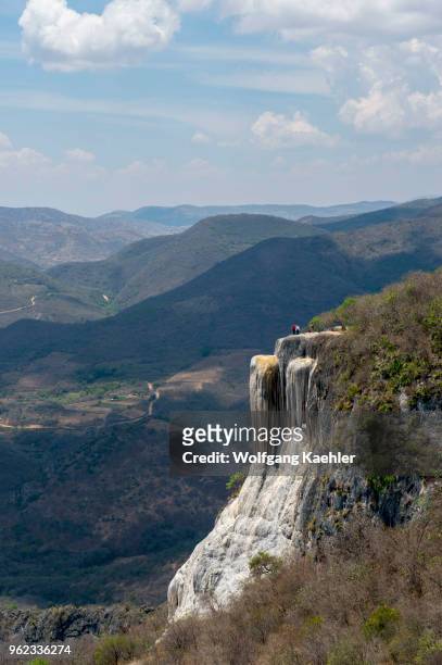 People at the large waterfall at Hierve el Agua, which is a deposit of calcium carbonate and other minerals, near Oaxaca, southern Mexico.