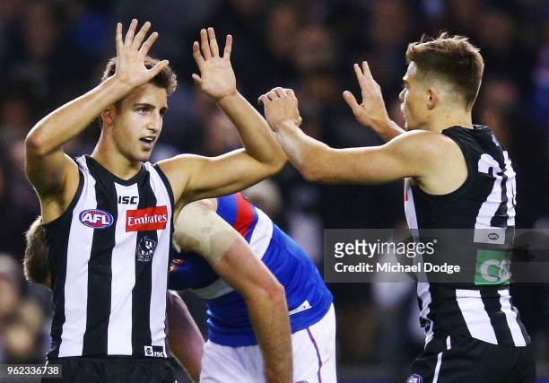 Josh Daicos of the Magpies and Josh Thomas of the Magpies celebrates a goal during the round 10 AFL match between the Collingwood Magpies and the...