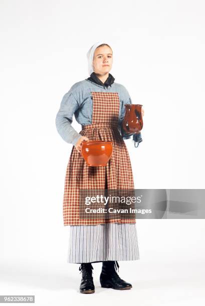 portrait of woman in colonial style maid costume against white background - period costume stock pictures, royalty-free photos & images