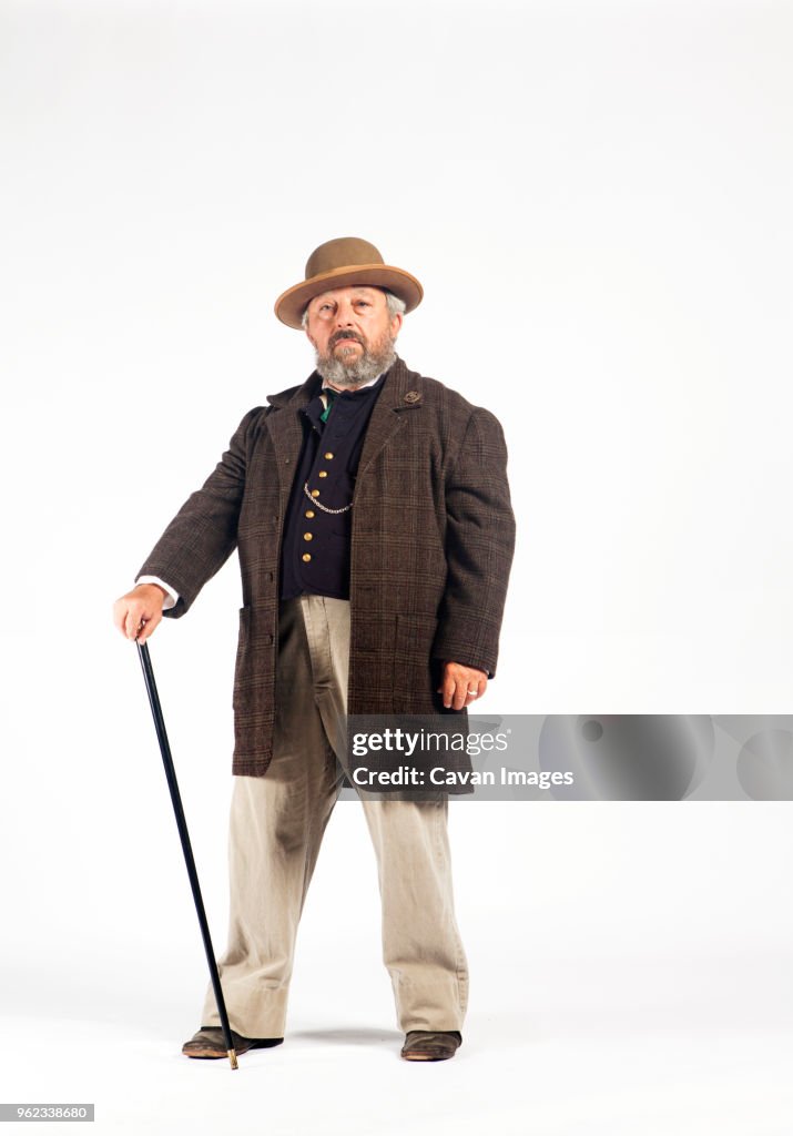 Portrait of serious man in retro styled costume against white background