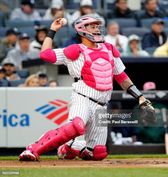 Catcher Gary Sanchez of the New York Yankees throws the ball back to the pitcher as he is outfitted in pink catchers gear as the Yankees and Oakland...