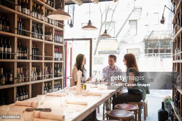 business people talking while sitting in restaurant - wine cellar stock pictures, royalty-free photos & images