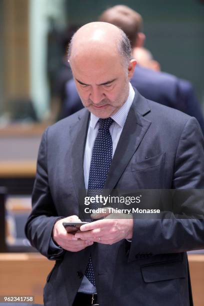 Economic and Financial Affairs, Taxation and Customs Commissioner Pierre Moscovici is looking at his smartphone during an EU EcoFin Ministers meeting...