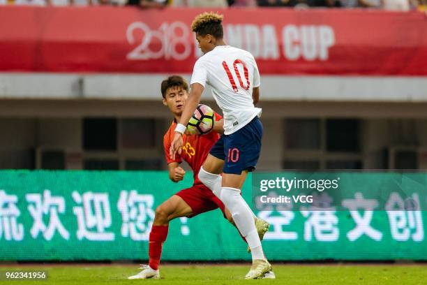 Felix Nmecha of England and Sun Qinhan of China compete for the ball during the 2018 Panda Cup International Youth Football Tournament between...