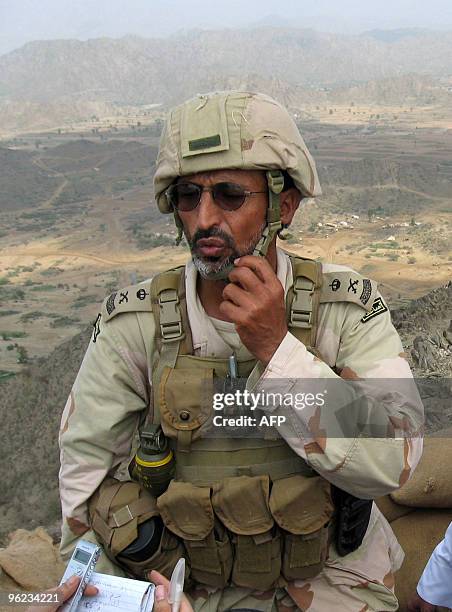 Saudi Major General Said speaks to reporters as he stands in a military post atop the Jebel Doud in Al-Khouba in the southern Jizan province, near...