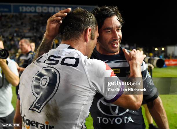 Johnathan Thurston of the Cowboys and Cameron Smith of the Storm share a laugh at the end of the round 12 NRL match between the North Queensland...