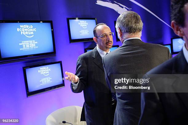 Khalid al-Falih, president and chief executive officer of Saudi Arabian Oil Co., left, speaks with Thierry Desmarest, chairman of Total SA, on day...