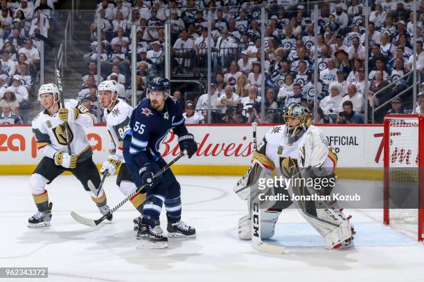 Mark Scheifele of the Winnipeg Jets stands among Cody Eakin, Nate Schmidt and goaltender Marc-Andre Fleury of the Vegas Golden Knights as they keep...