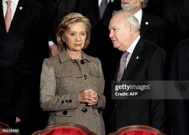 Secretary of State Hillary Clinton speaks with Spainish Foreign Minister Miguel Angel Moratinos before posing for a group photograph ahead of the...