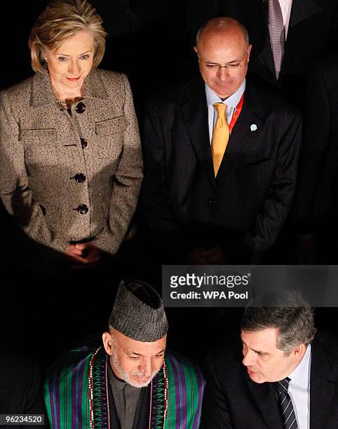 Afghan President Hamid Karzai sits beside British Prime Minister Gordon Brown in front of U.S. Secretary of State Hillary Clinton and Asia...