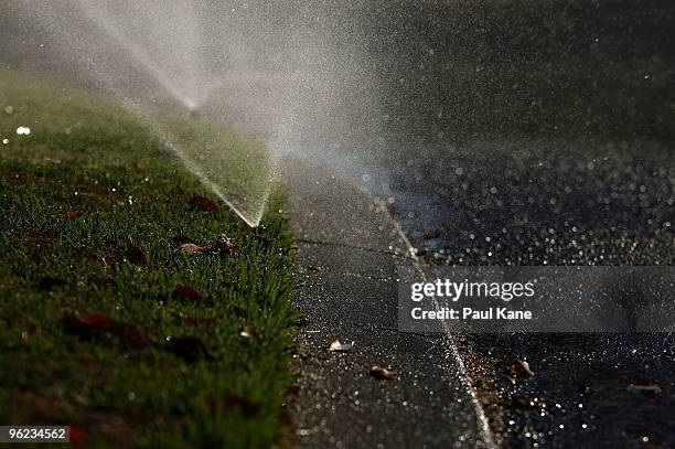 Sprinklers are pictured watering a residential lawn as Perth moves closer to suffering the longest drought on record, with today marking 69...