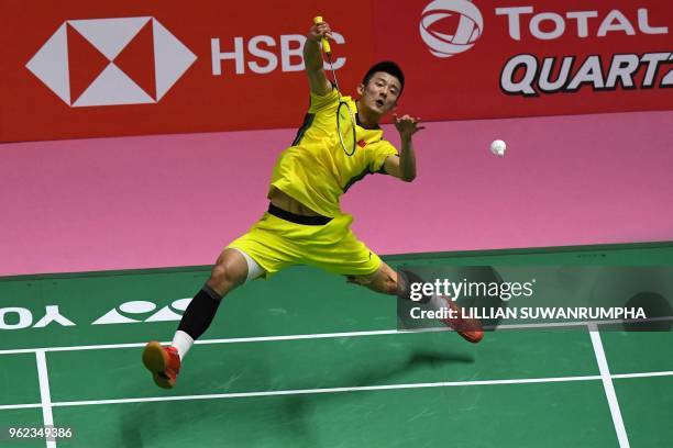 Chen Long of China hits a return against of Anthony Sinisuka Ginting of Indonesia during their men's singles semifinals match at the Thomas and Uber...