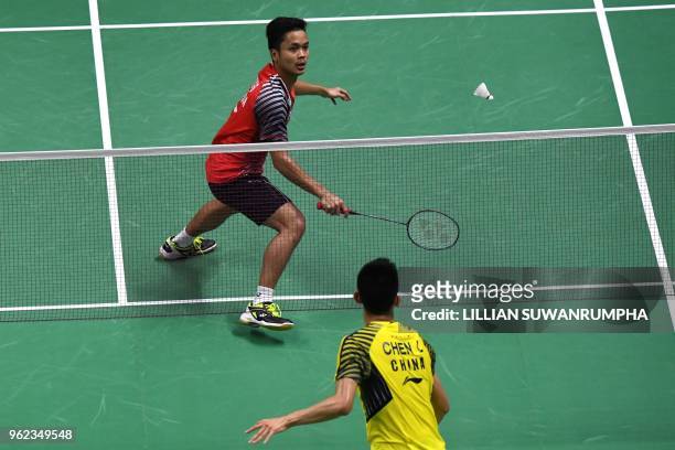 Anthony Sinisuka Ginting of Indonesia hits a return against Chen Long of China during their men's singles semifinals match at the Thomas and Uber Cup...