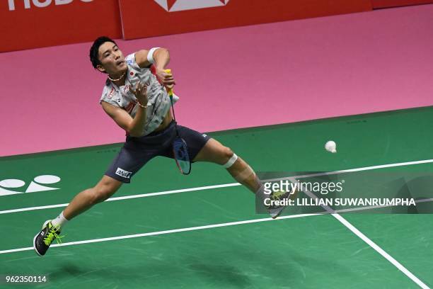 Kento Momota of Japan hits a return against Viktor Axelsen of Denmark during their men's singles semifinals match at the Thomas and Uber Cup...