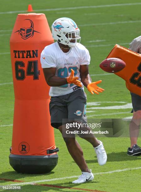 Francis Owusu of the Miami Dolphins catches the ball during the teams training camp on May 23, 2018 at the Miami Dolphins training facility in Davie,...