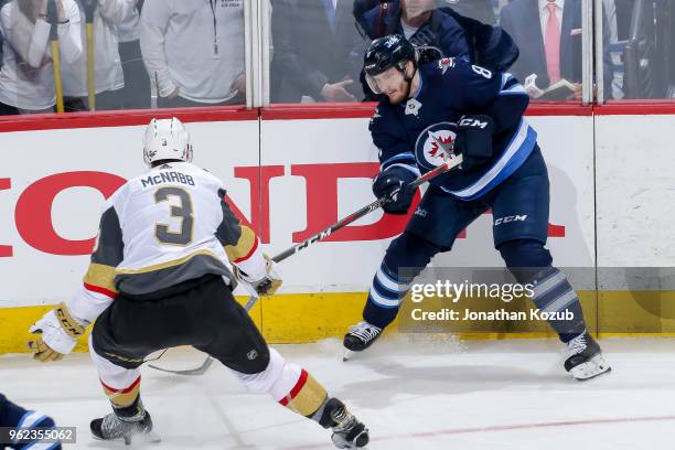 Jacob Trouba of the Winnipeg Jets plays the puck along the boards as Brayden McNabb of the Vegas Golden Knights defends during second period action...