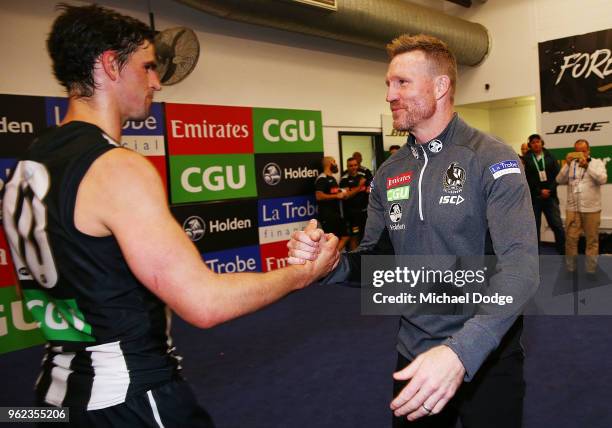 Magpies head coach Nathan Buckley celebrates the win with Scott Pendlebury of the Magpies during the round 10 AFL match between the Collingwood...