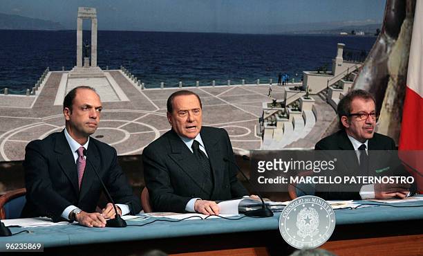Italian Prime Minister Silvio Berlusconi flanked by ministers Angelino Alfano and Roberto Maroni, speaks during a press confrerence following an...