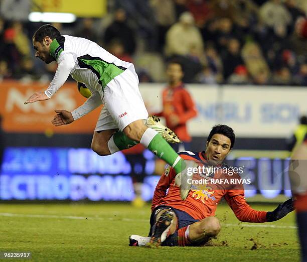 Osasuna's Iranian Javad Nekuoman vies with Racing's Mehdi Lacen during a Spanish King's Cup quarter finals second leg match at Reyno de Navarra...