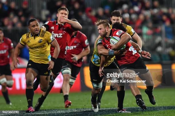 Braydon Ennor of the Crusaders is tackled by Ardie Savea of the Hurricanes during the round 15 Super Rugby match between the Crusaders and the...