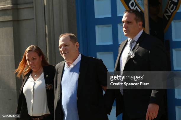 Harvey Weinstein is led out of the New York Police Department's First Precinct in handcuffs after being arrested and processed on charges of rape,...