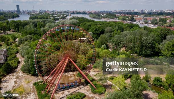 An elevated view shows a Giant Wheel at the abandoned former GDR pleasure ground "Spreepark" in the Plaenter forest in Berlin, on May 25, 2018. /...