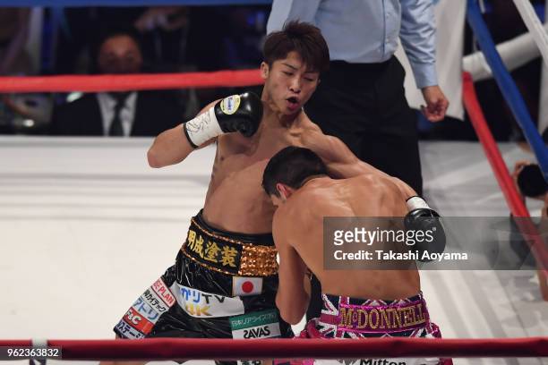 Naoya Inoue of Japan punches champion Jamie McDonnell of Great Britain during their WBA Bantamweight Title Bout at Ota-City General Gymnasium on May...