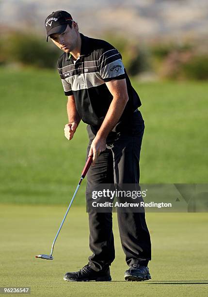 Oliver Wilson of England celebrates after holing a par putt on the 17th hole during the first round of the Commercialbank Qatar Masters at Doha Golf...